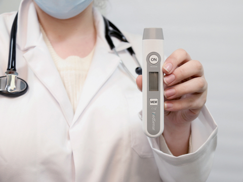 Doctor holding MedSense digital thermometer in hand