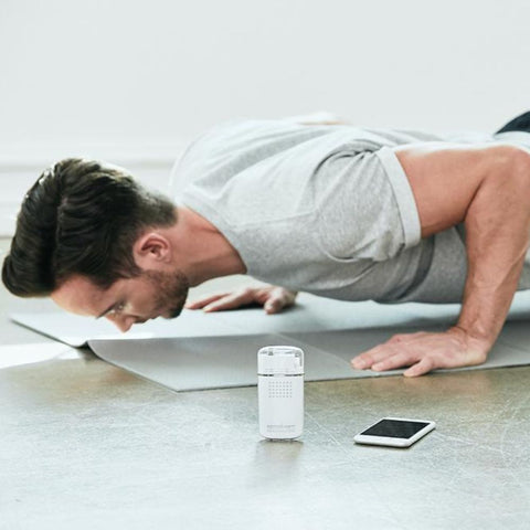 A man working out with KetoScan Mini Ketone Breath Meter