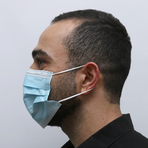 A man wearing the MedSense Disposable Face Masks with Ear Loops (FM1) side angle