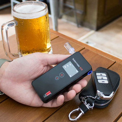 A man holding the Sobermate S5 Personal Breathalyser